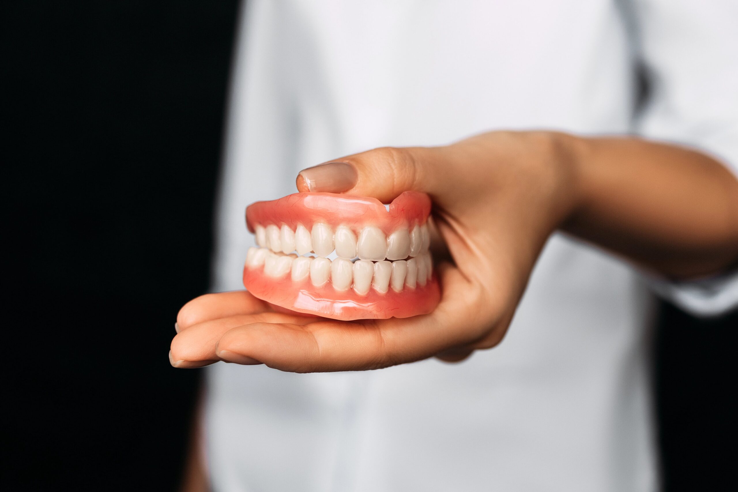 Close-up of dentist holding dentures