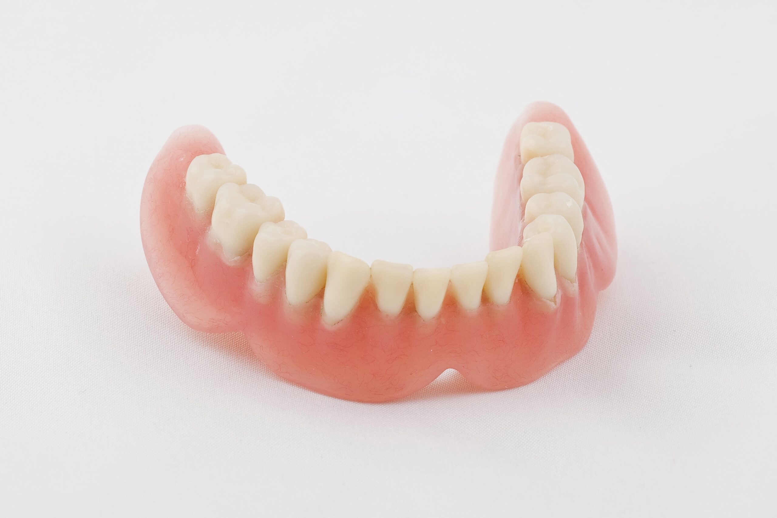 Set of lower dentures on white background