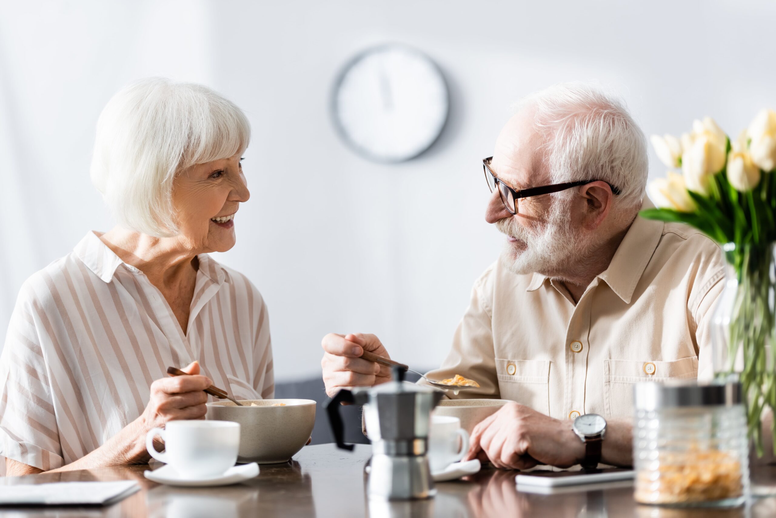 Two seniors eating happily